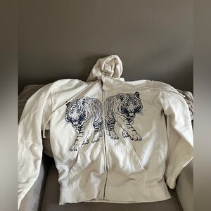 white/creamy jacket that has blue tigers in both sides! size small/medium!